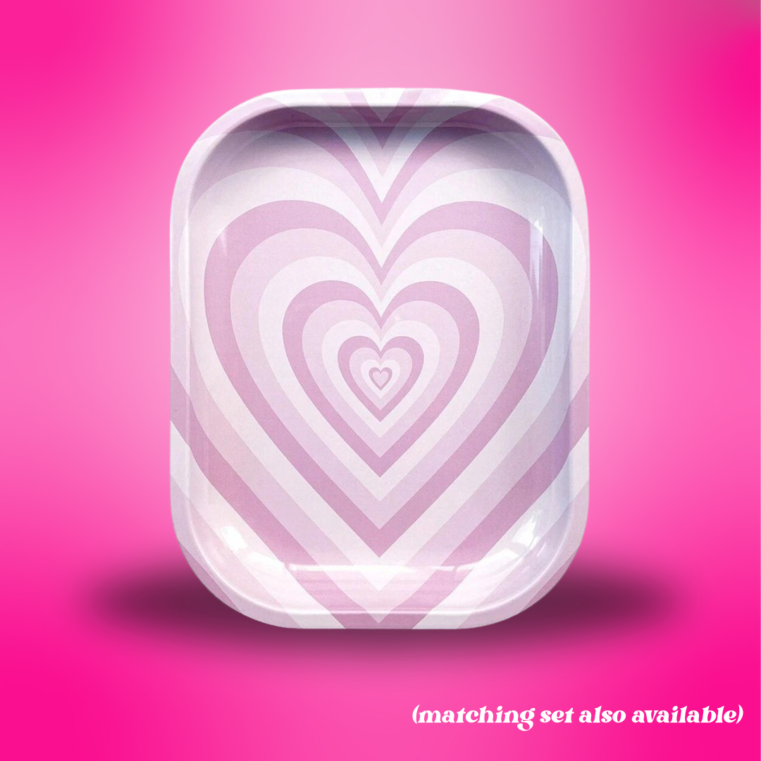 Heart-shaped tray with concentric circles on a pink background